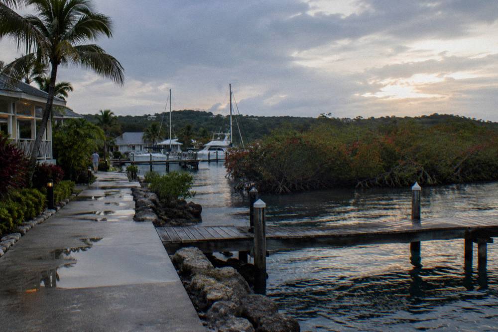 Calm shallow lagoon water at dusk with gentle ripples near a wooden dock