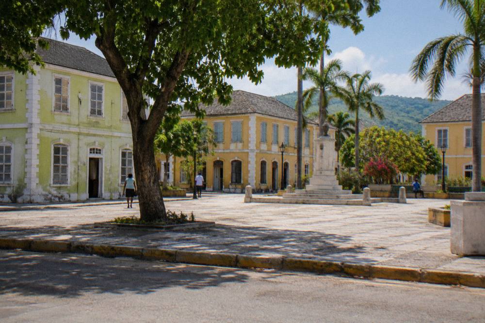 Georgian stone buildings around a town square under a bright sky