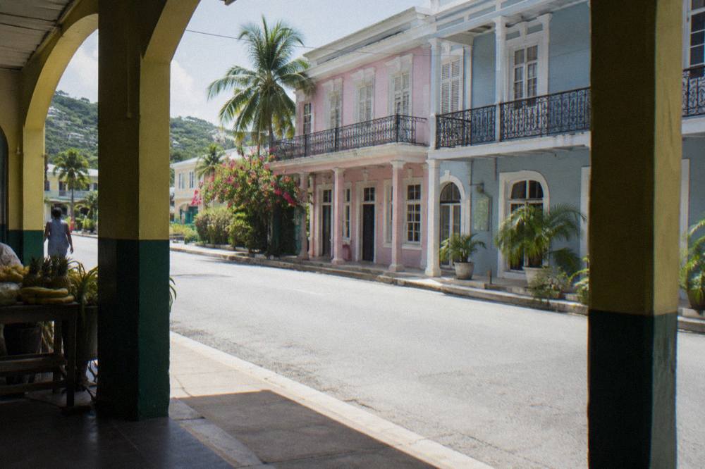 Pastel-colored Georgian facades and ironwork balconies on a sunny Falmouth street