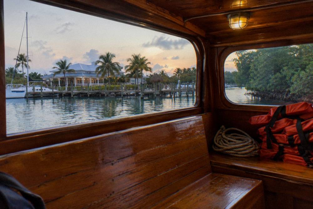 Tour boat cabin interior lit softly before a night departure