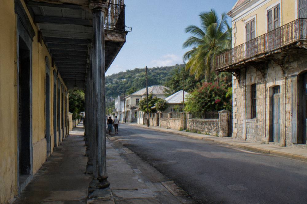 Historic Georgian stone buildings along a quiet Caribbean town street