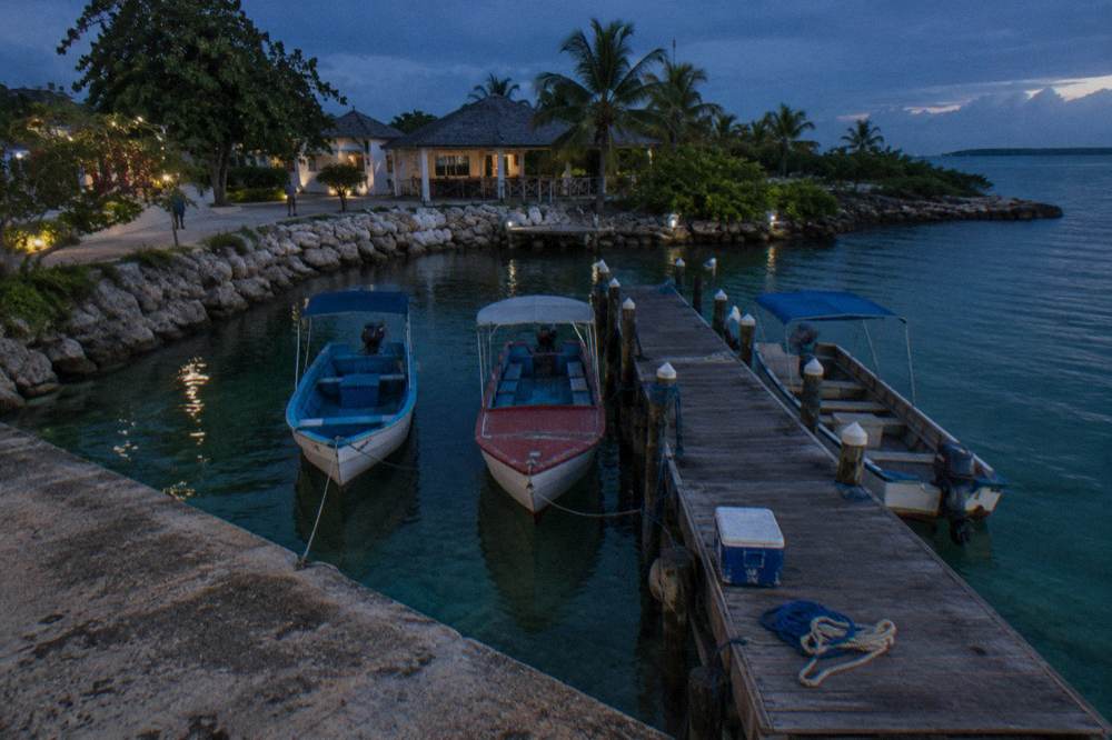 Boats at a marina dock under deep blue twilight sky