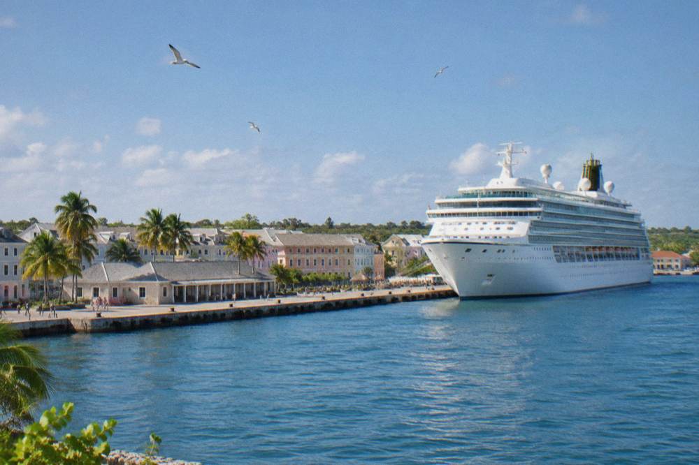 A large cruise ship docked at a pier beside a small port town in morning light