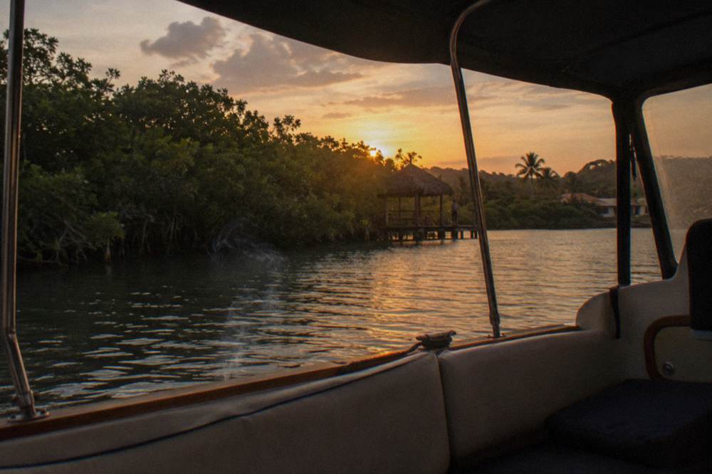 Evening air over still lagoon water with mangrove silhouettes at the shoreline