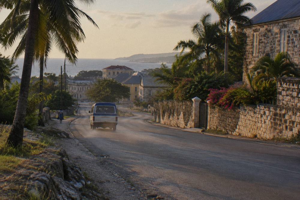 Coastal highway road at dusk with palms along the shoulder