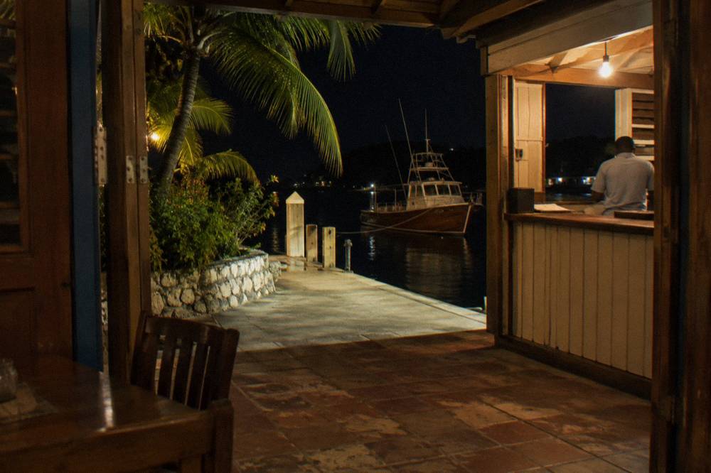 Ticket desk and dock at a marina restaurant lit warmly at night